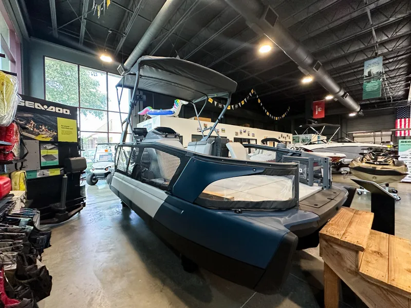 Slide: The Image of 2025 Sea-Doo Switch Sport 18 displayed in a showroom with various watercraft. - 3