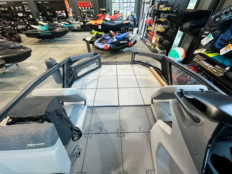 Slide: The Image of 2025 Sea-Doo Switch Sport 18 interior in showroom, showcasing seating and deck layout. - 4