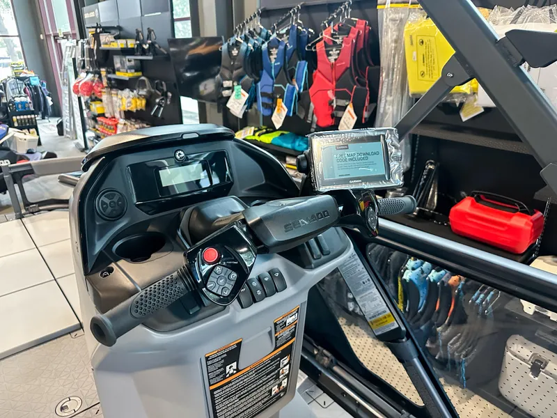 Slide: The Image of Cockpit view of 2025 Sea-Doo Switch Sport 18, showcasing controls and display in a showroom. - 5