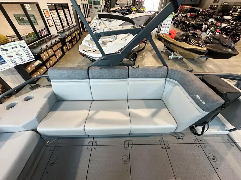 Slide: The Image of 2025 Sea-Doo Switch Sport 18 interior with gray seating in showroom. - 8