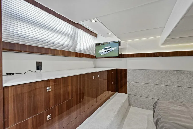 Slide: The Image of 2023 Cruisers Yachts 42 Cantius interior with wood cabinetry and mounted TV. - 14