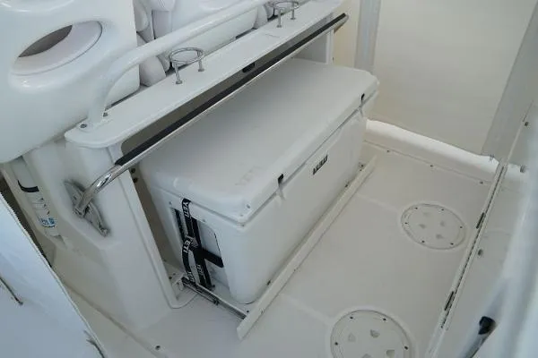 Slide: The Image of 2016 Everglades 435CC boat interior with secured white cooler and seating area. - 15