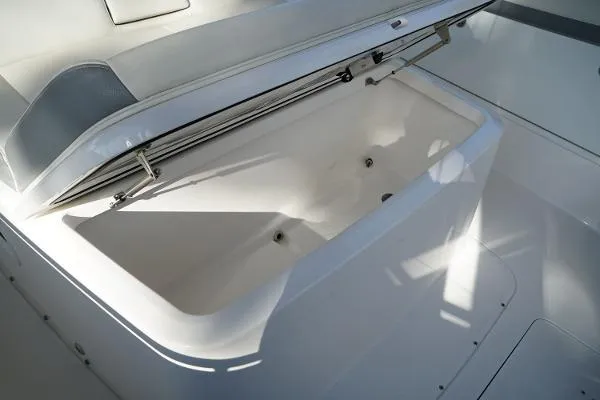 Slide: The Image of Open storage compartment on a 2016 Everglades 435CC boat, showcasing interior space. - 16