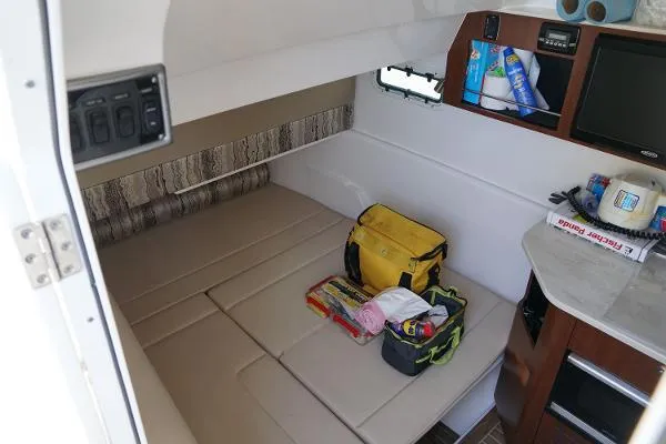 Slide: The Image of Interior cabin of 2016 Everglades 435CC boat with storage and seating area. - 20