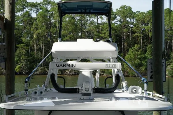 Slide: The Image of 2016 Everglades 435CC boat with Garmin xHD2 radar, docked near lush forest. - 27