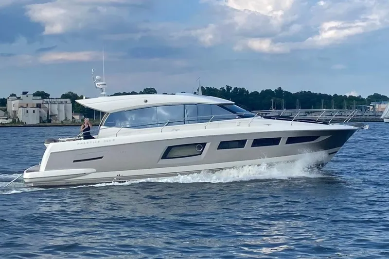 The Image of 2015 Prestige 500 S yacht cruising on open water under a cloudy sky. - 0