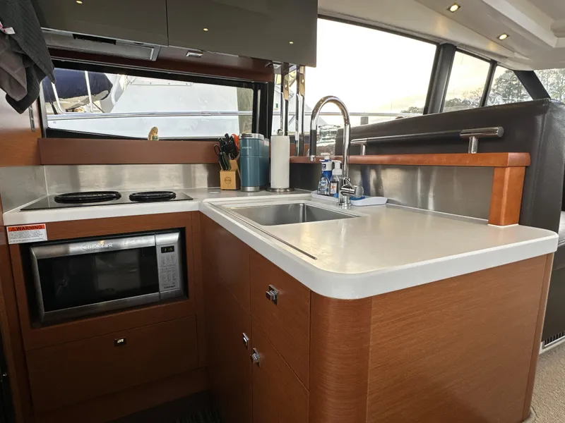 Slide: The Image of Modern kitchen interior of 2015 Prestige 500 S yacht with sink, stove, and microwave. - 14