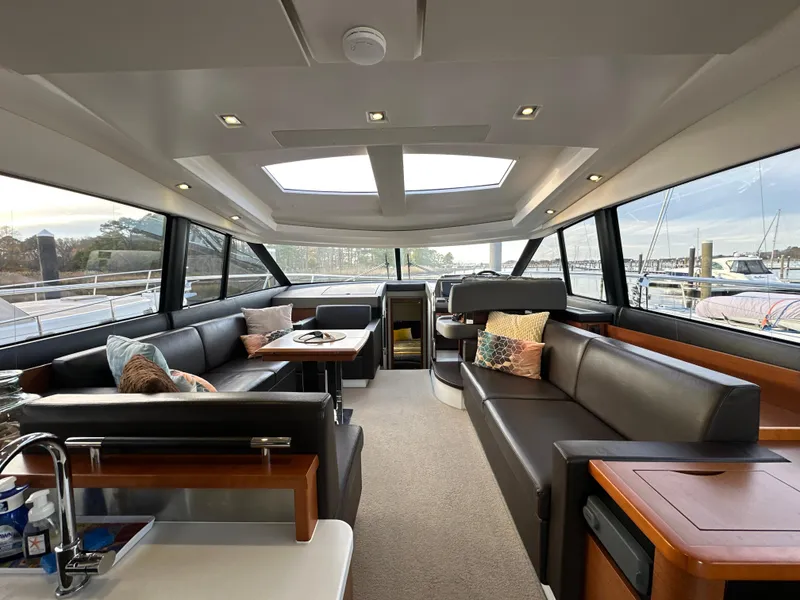 Slide: The Image of Luxurious interior of a 2015 Prestige 500 S yacht with modern seating and panoramic windows. - 16