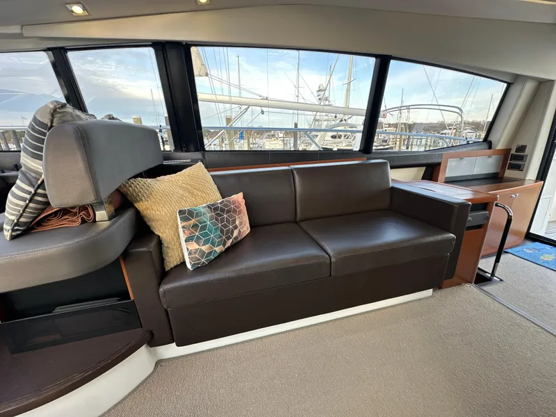 Slide: The Image of Interior of 2015 Prestige 500 S yacht with leather sofa and decorative pillows. - 19