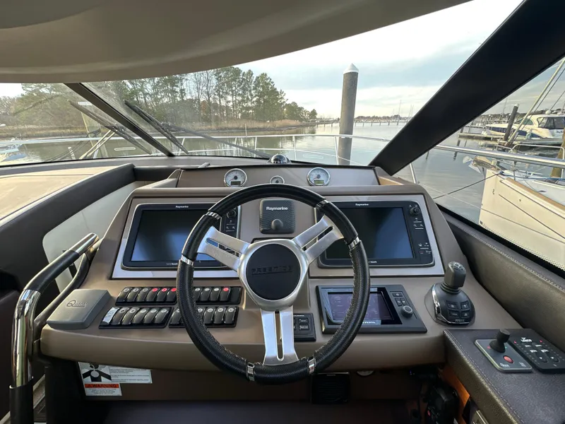 Slide: The Image of Prestige 500 S 2015 yacht helm with modern navigation controls and steering wheel. - 21