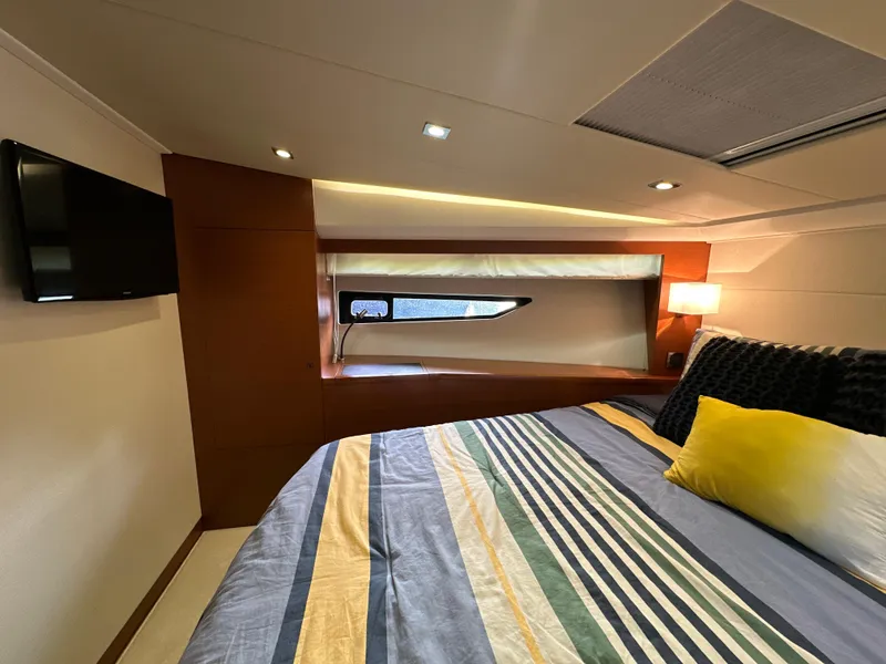 Slide: The Image of Luxurious cabin interior of 2015 Prestige 500 S yacht with modern bedding and ambient lighting. - 27