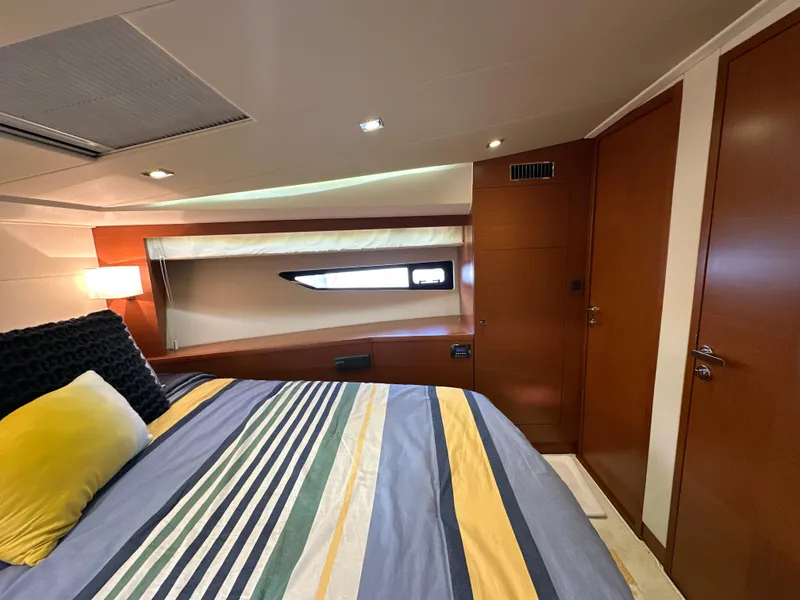 Slide: The Image of Luxurious bedroom interior of 2015 Prestige 500 S yacht with striped bedding and modern design. - 28