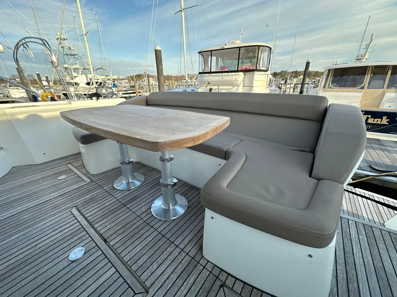 Slide: The Image of Prestige 500 S 2015 yacht deck with seating and table, docked at marina. - 3