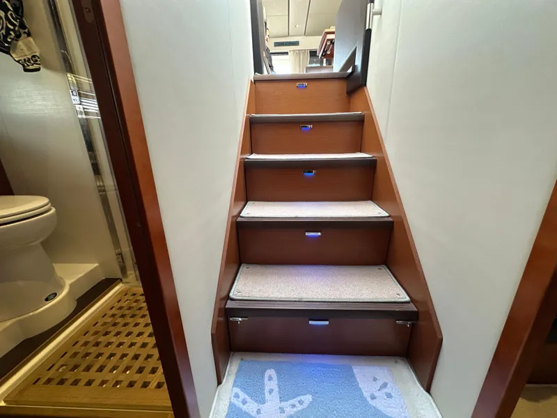 Slide: The Image of Staircase inside 2015 Prestige 500 S yacht, with carpeted steps and adjacent bathroom. - 32