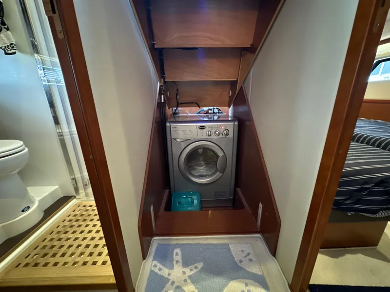Slide: The Image of Laundry area with washing machine in 2015 Prestige 500 S yacht interior. - 33