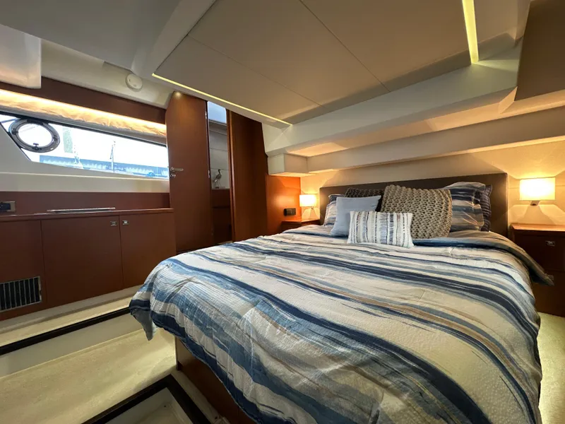 Slide: The Image of Luxurious bedroom interior of a 2015 Prestige 500 S yacht with striped bedding. - 35