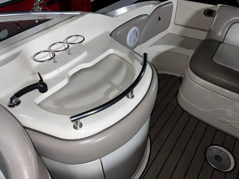 Slide: The Image of 2002 Sea Ray 270 Sundeck interior with seating and cup holders on deck. - 10