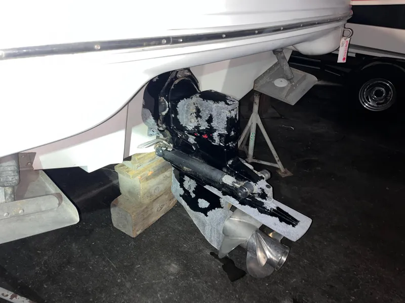 Slide: The Image of 2002 Sea Ray 270 Sundeck boat outdrive on blocks in a garage. - 13