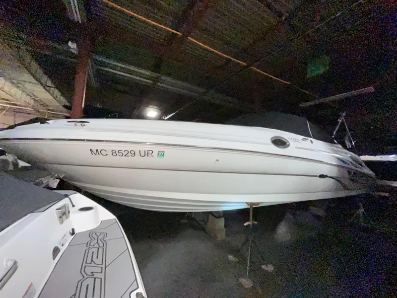 Slide: The Image of 2002 Sea Ray 270 Sundeck boat stored indoors, side view. - 2