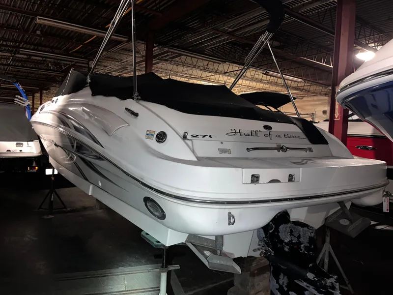Slide: The Image of 2002 Sea Ray 270 Sundeck boat in indoor storage, rear view. - 3
