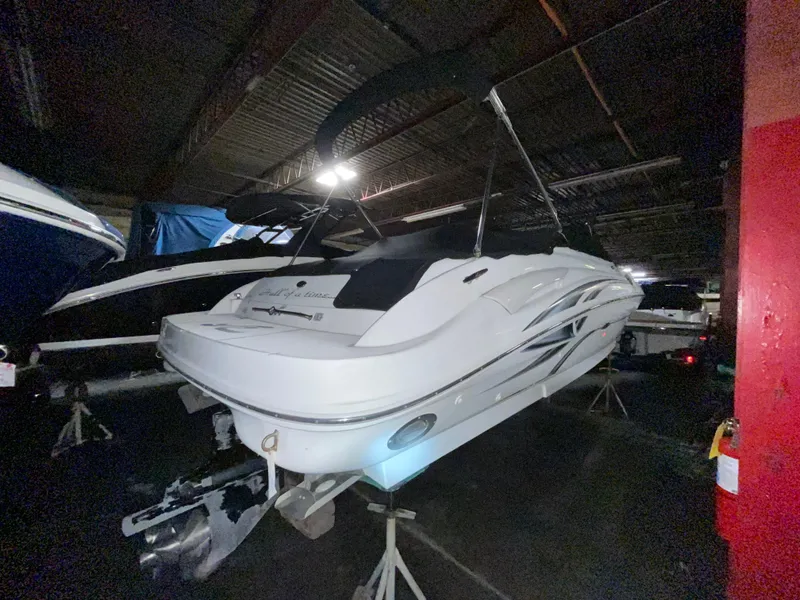 Slide: The Image of 2002 Sea Ray 270 Sundeck boat in indoor storage, elevated on stands. - 4