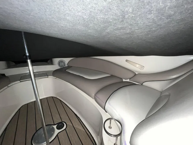 Slide: The Image of 2002 Sea Ray 270 Sundeck interior with cushioned seating and wooden flooring. - 6