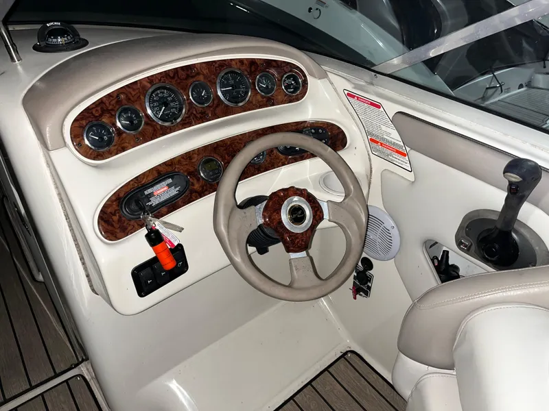 Slide: The Image of 2002 Sea Ray 270 Sundeck dashboard with steering wheel and instrument panel. - 7
