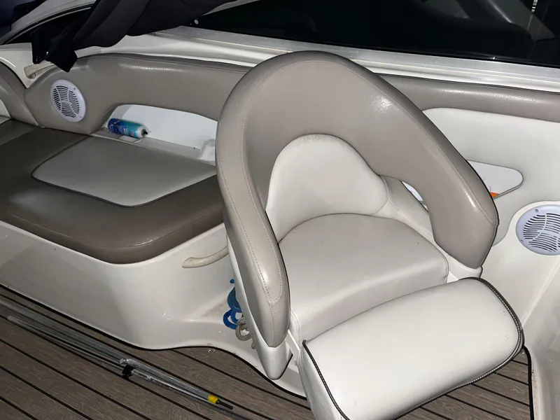 Slide: The Image of 2002 Sea Ray 270 Sundeck interior with beige seating and wood-textured flooring. - 9