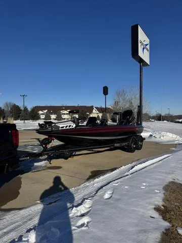 Slide: The Image of 2025 Skeeter ZXR20 boat on snowy parking lot under clear blue sky. - 6