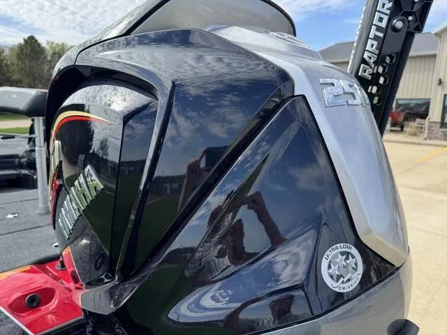 Slide: The Image of 2025 Skeeter ZXR20 boat in showroom, sleek design with red accents, on trailer. - 5