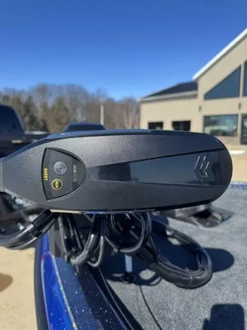 Slide: The Image of 2025 Skeeter ZXR21 boat control panel with buttons, outdoors. - 2