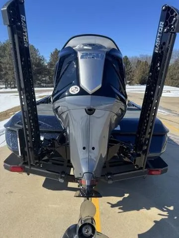 Slide: The Image of 2025 Skeeter ZXR21 boat with dual Raptor anchors, parked on a sunny day. - 3