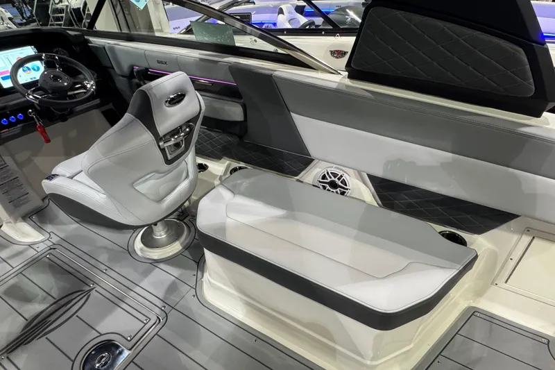 Slide: The Image of 2025 Chaparral 2870 SSX boat interior with blue LED lighting and seating area. - 10