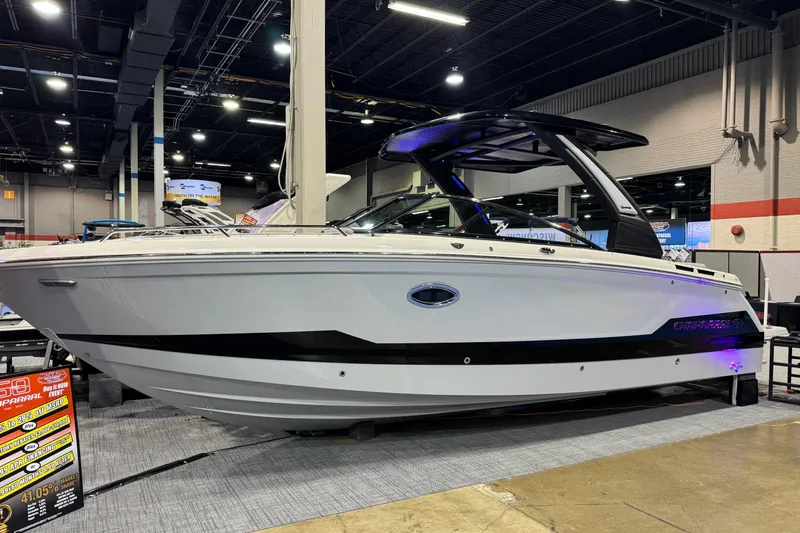 Slide: The Image of 2025 Chaparral 2870 SSX boat in a warehouse, sleek design, on a trailer. - 2