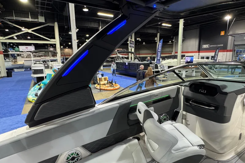 Slide: The Image of 2025 Chaparral 2870 SSX boat interior with gray seating and a round table. - 8