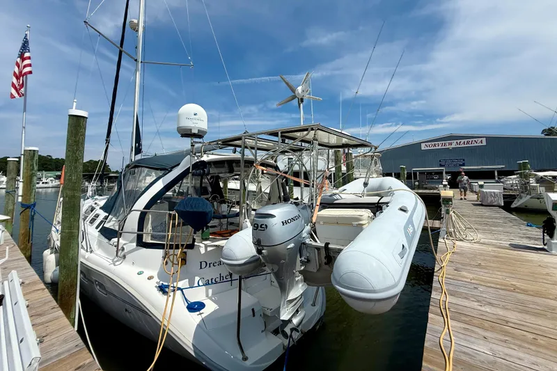 Slide: The Image of Hunter 410 sailboat docked at Norview Marina, featuring a Honda outboard motor, 1998 model. - 15