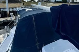 Slide: The Image of Hunter 410 sailboat from 1998 with blue canvas cover docked at marina. - 18