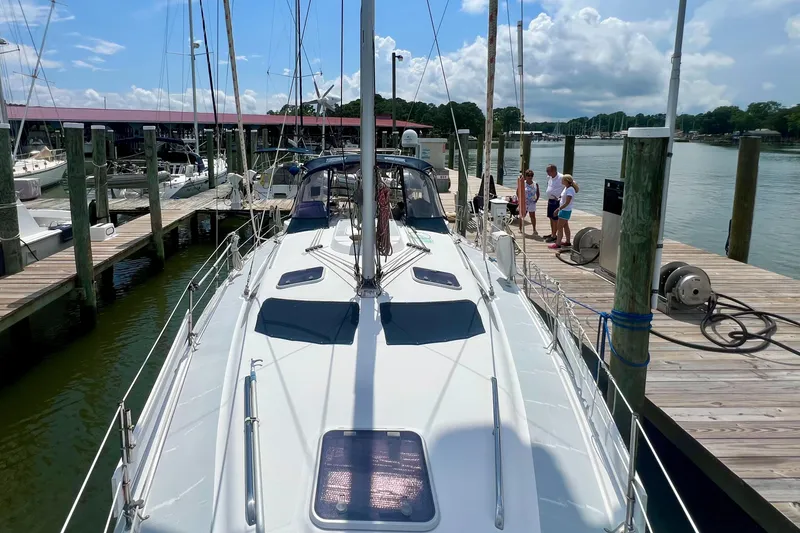Slide: The Image of Sailboat docked at marina, Hunter 410 model, 1998, with people on the pier. - 19