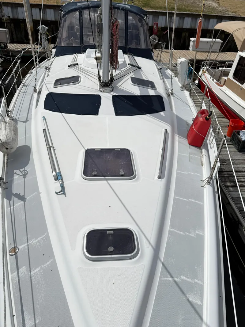 Slide: The Image of 1998 Hunter 410 sailboat deck with hatches and rigging, docked at marina. - 20