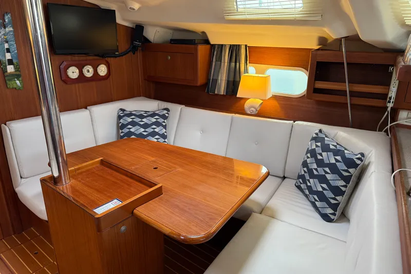 Slide: The Image of Interior of a 1998 Hunter 410 sailboat with cozy seating and wooden table. - 27