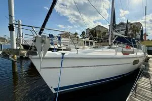 Slide: The Image of 1998 Hunter 410 sailboat docked at marina under blue sky. - 3