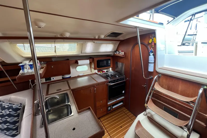 Slide: The Image of Interior of 1998 Hunter 410 sailboat with kitchen and seating area. - 30