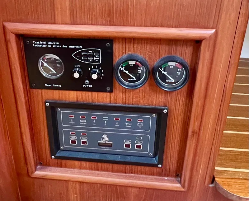 Slide: The Image of Control panel of a 1998 Hunter 410 boat with gauges and switches. - 32