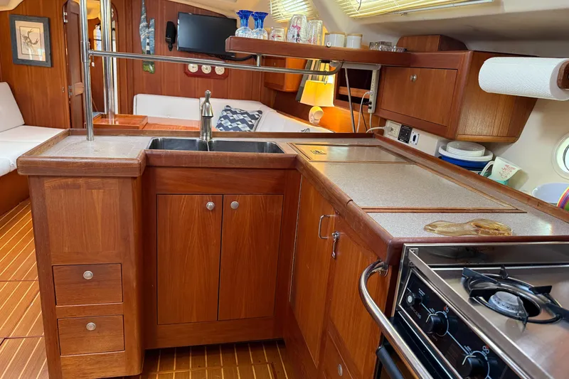 Slide: The Image of Luxurious wooden kitchen interior of 1998 Hunter 410 yacht with modern amenities. - 36