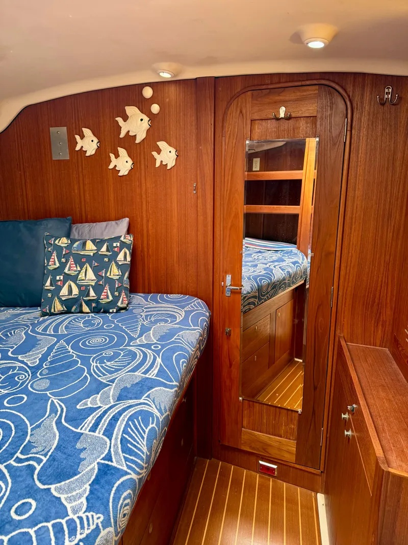 Slide: The Image of Cozy cabin interior of 1998 Hunter 410 sailboat with nautical decor and wooden finishes. - 41