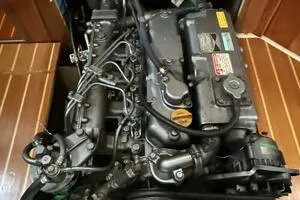 Slide: The Image of Engine of a 1998 Hunter 410 sailboat, showcasing intricate mechanical components. - 43