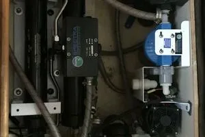 Slide: The Image of Engine compartment of a 1998 Hunter 410 boat, featuring mechanical components and hoses. - 44