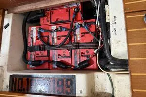 Slide: The Image of Battery compartment of a 1998 Hunter 410 sailboat with red batteries and wiring. - 45