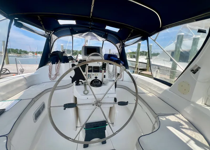 Slide: The Image of Cockpit of a 1998 Hunter 410 sailboat with steering wheel and navigation equipment. - 6
