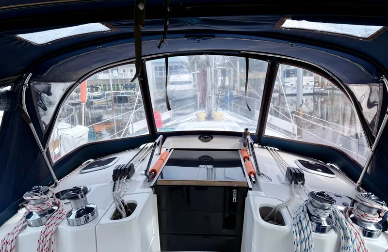 Slide: The Image of Interior view of a 1998 Hunter 410 sailboat cockpit with winches and ropes. - 8